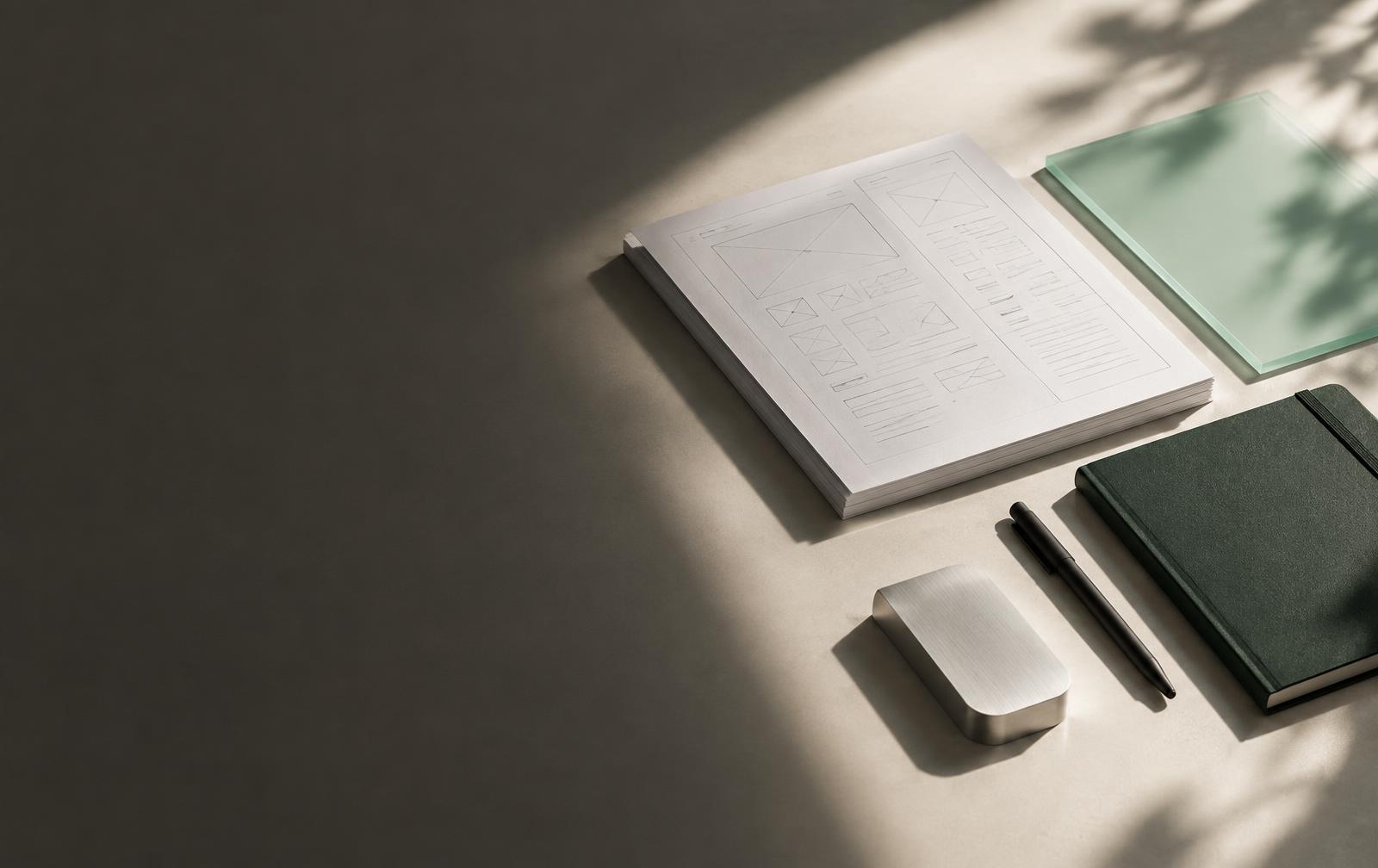 Product sketches, a notebook, and prototyping materials on a desk